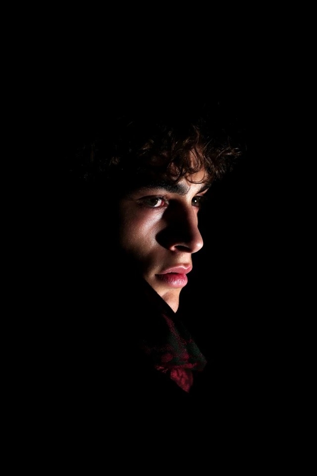 Dramatic chiaroscuro with a dark palette and stark contrast