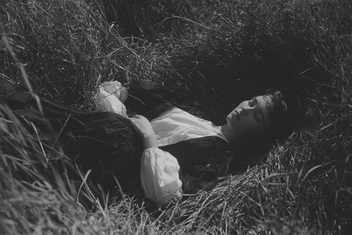 Grey Saturn lying in the grass shot