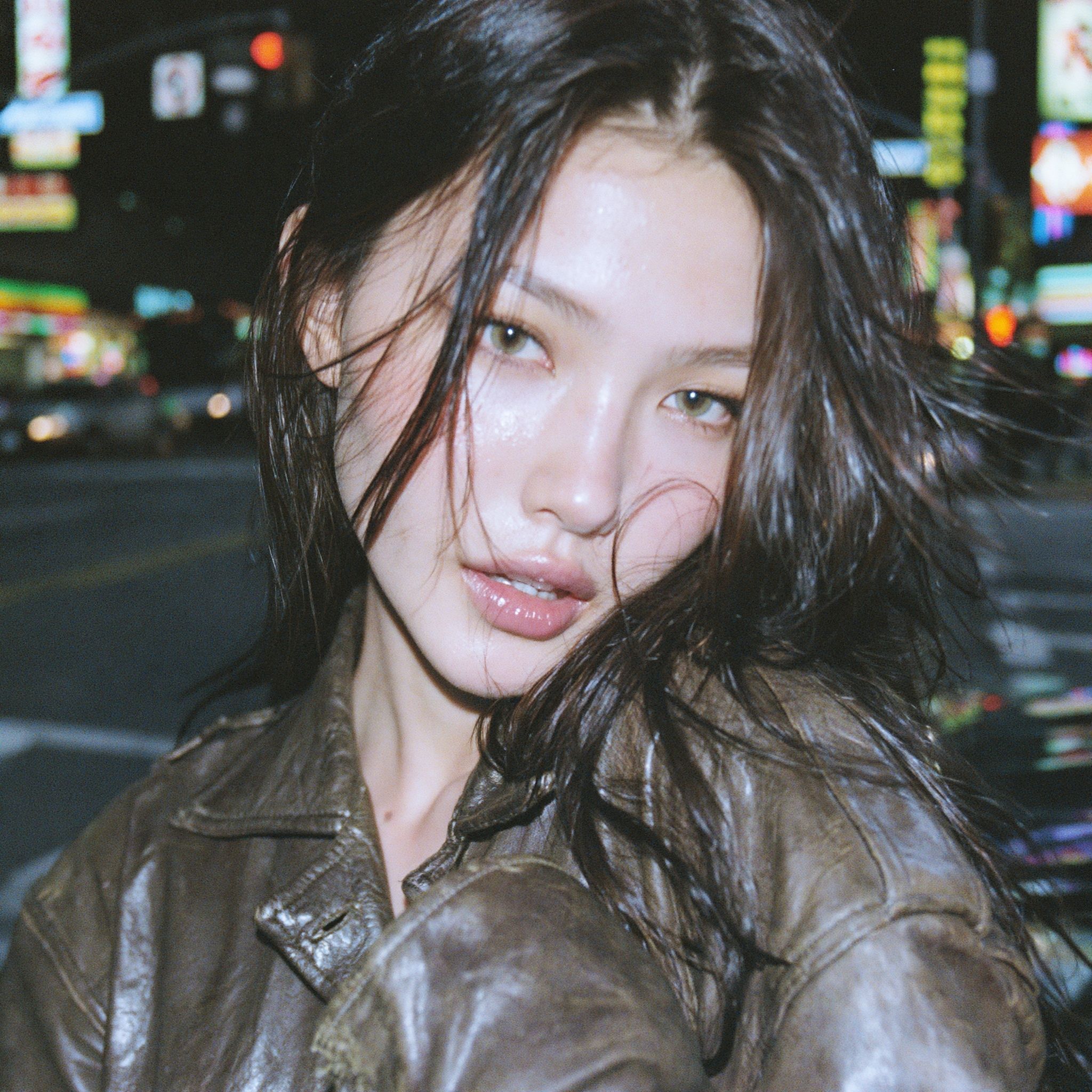 A beautiful young woman in a night street portrait showcases natural charm and a captivating gaze