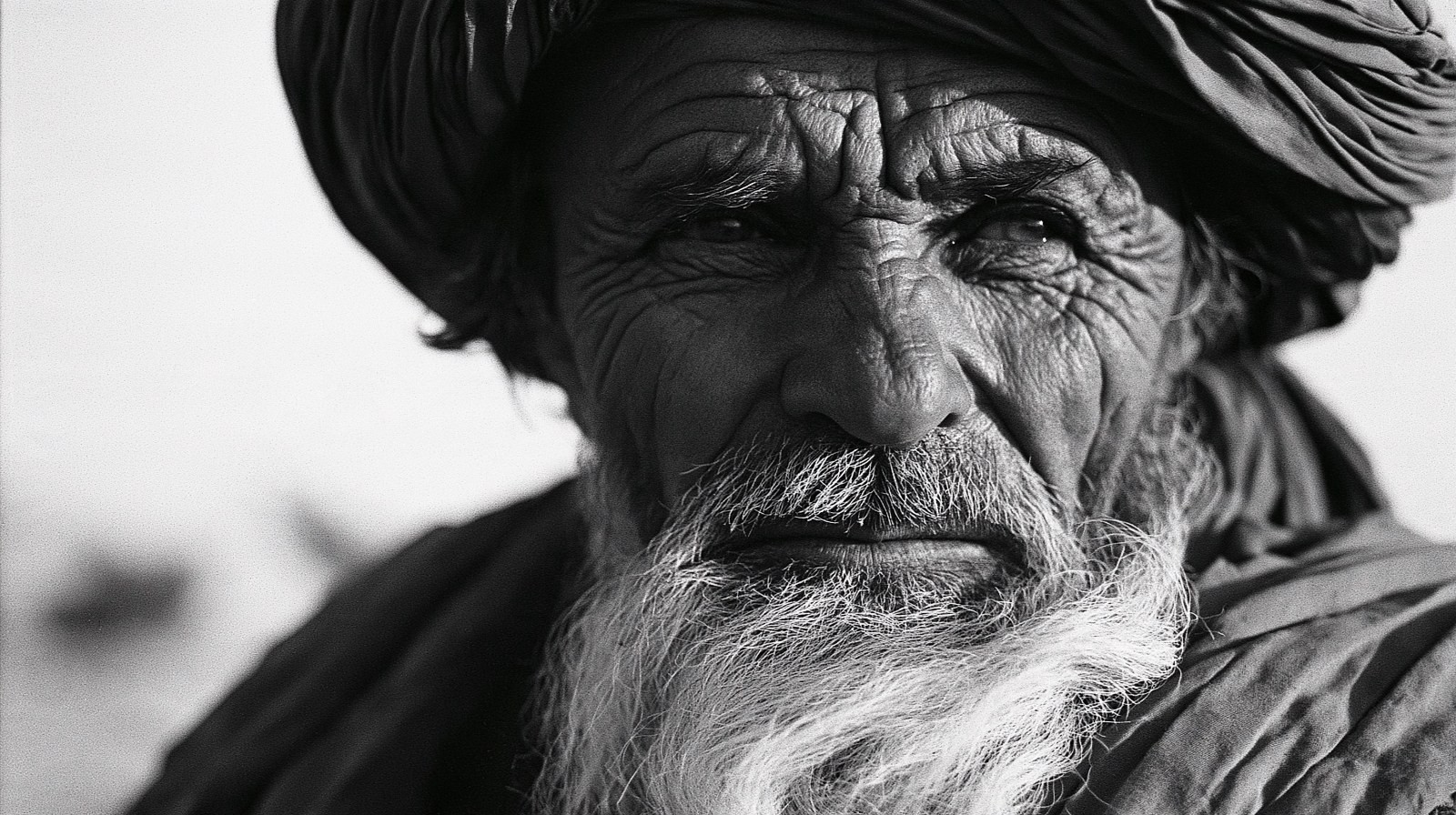 A black and white portrait of an elderly man showcases the passage of time and a deep cultural atmosphere